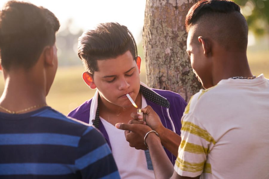 Kids smoking cigarette in park