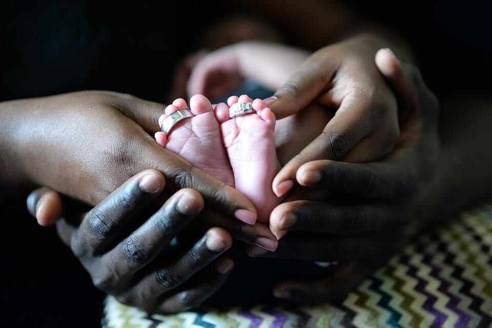 Mother and father holding a baby