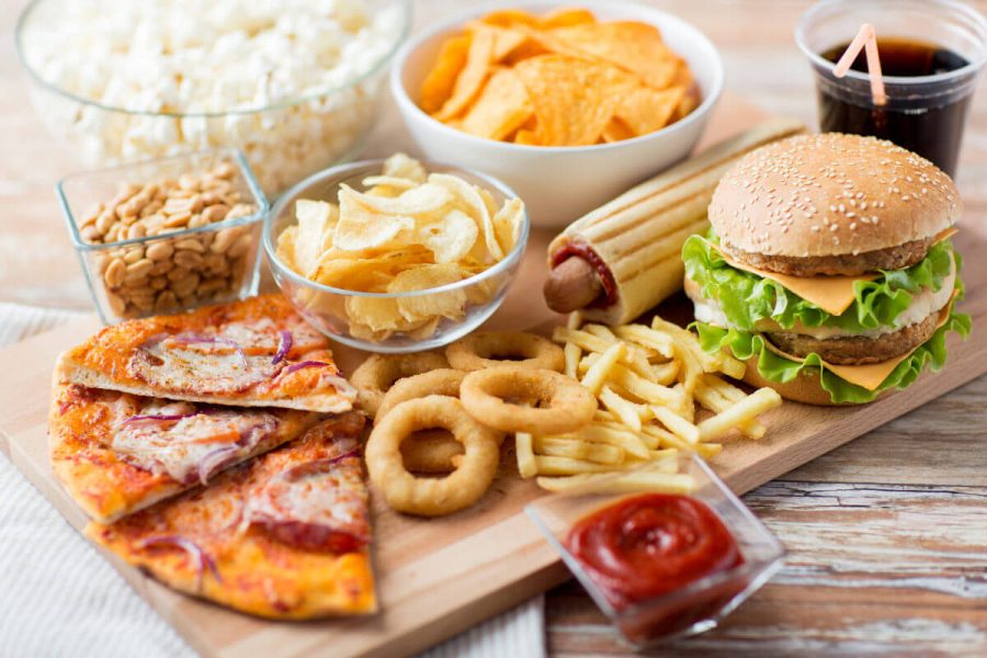 fast food and unhealthy eating concept - close up of fast food s