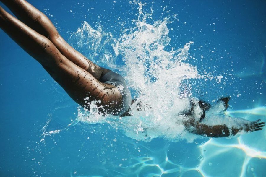 woman diving into a pool