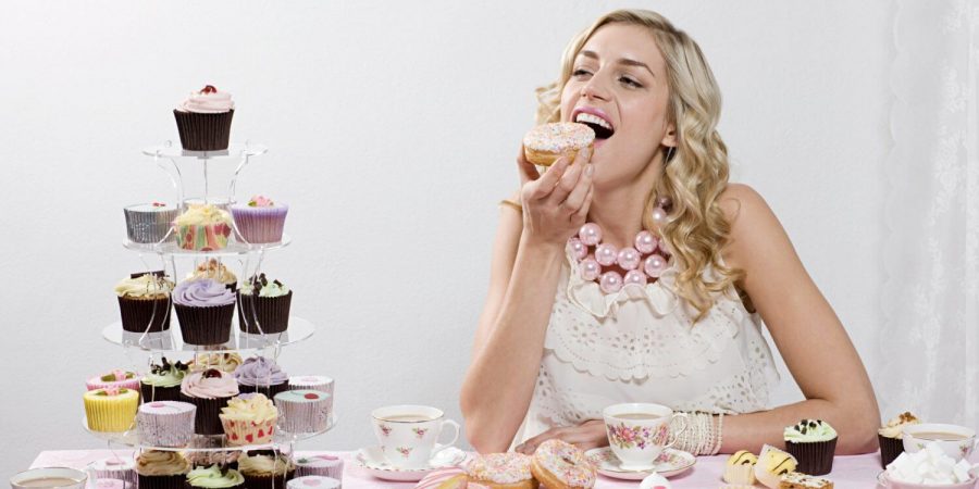 a person eating cupcakes