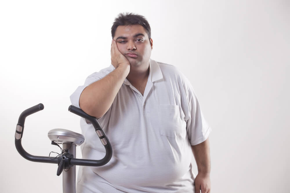 obese man with an exercise bike